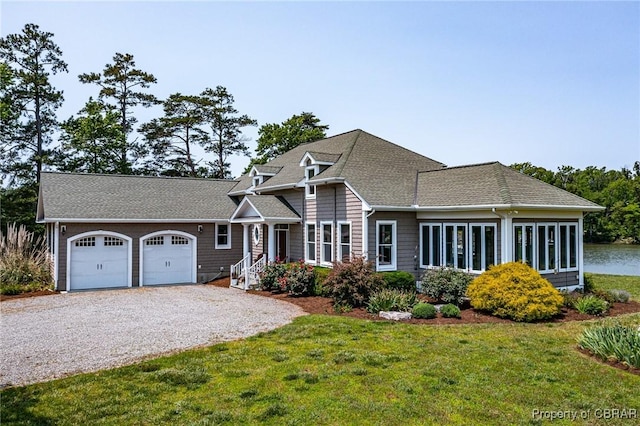 241 Tranquility Rd, Reedville, VA 22539 - view of front of home with gravel driveway, a garage, a front yard, and a shingled roof