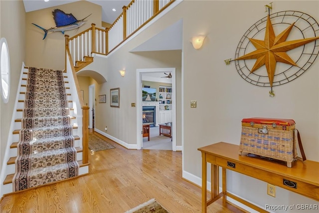 241 Tranquility Rd, Reedville, VA 22539 - foyer with stairway, wood finished floors, baseboards, arched walkways, and a towering ceiling