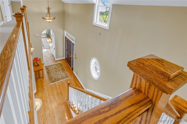 241 Tranquility Rd, Reedville, VA 22539 - foyer with wood finished floors, a towering ceiling, baseboards, and arched walkways