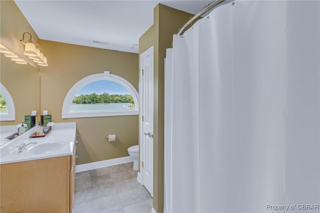 241 Tranquility Rd, Reedville, VA 22539 - full bathroom with vanity, toilet, healthy amount of natural light, and tile patterned floors