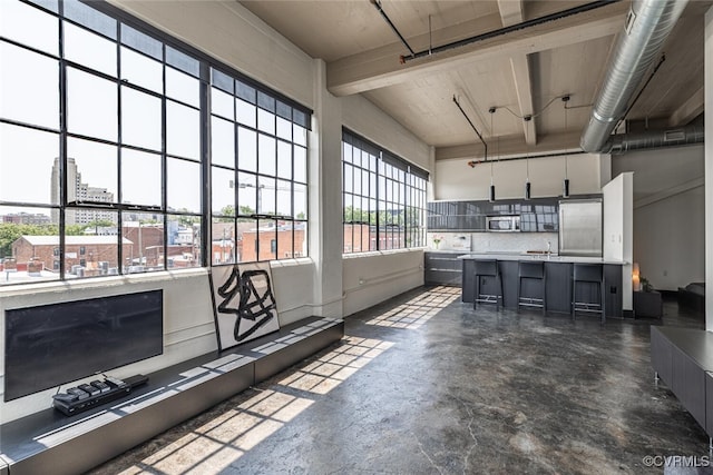 101 W Marshall St Unit U47, Richmond, VA 23220 - kitchen featuring stainless steel appliances, concrete flooring, a kitchen breakfast bar, light countertops, and backsplash