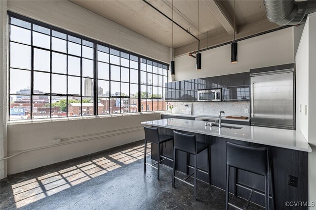 101 W Marshall St Unit U47, Richmond, VA 23220 - kitchen featuring stainless steel appliances, concrete flooring, a sink, decorative backsplash, and light countertops