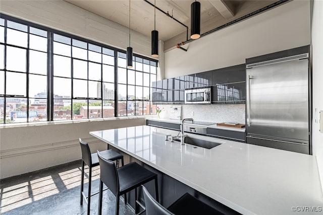 101 W Marshall St Unit U47, Richmond, VA 23220 - kitchen featuring a sink, appliances with stainless steel finishes, backsplash, and light countertops