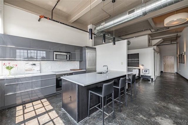 101 W Marshall St Unit U47, Richmond, VA 23220 - kitchen featuring modern cabinets, a towering ceiling, stainless steel appliances, gray cabinetry, and a kitchen breakfast bar