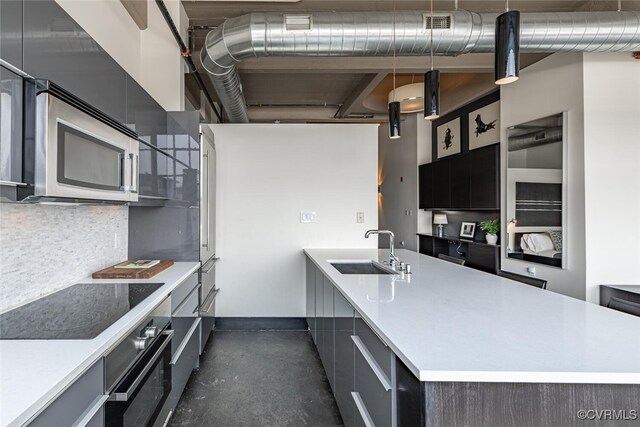 101 W Marshall St Unit U47, Richmond, VA 23220 - kitchen with appliances with stainless steel finishes, a sink, modern cabinets, light countertops, and backsplash