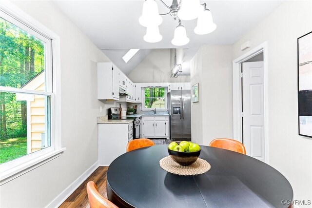 4381 Three Bridge Rd, Powhatan, VA 23139 - dining room with dark wood-style flooring, a chandelier, baseboards, and vaulted ceiling
