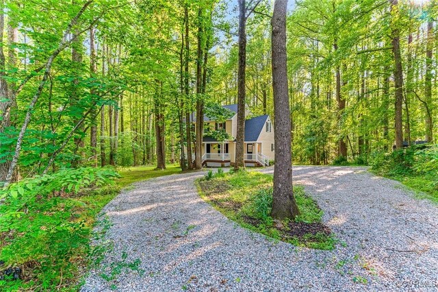 4381 Three Bridge Rd, Powhatan, VA 23139 - a-frame home featuring curved driveway and a wooded view