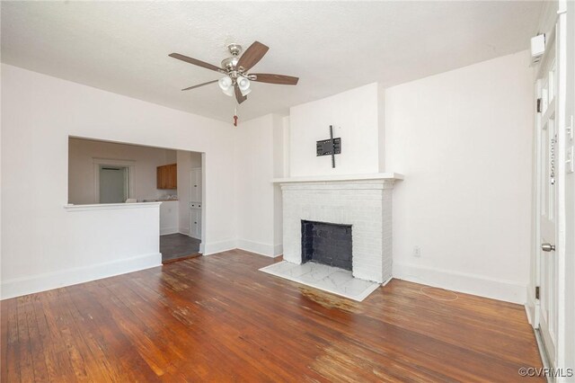 2007 Albany Ave, Richmond, VA 23224 - unfurnished living room featuring ceiling fan, wood-type flooring, a fireplace, and baseboards