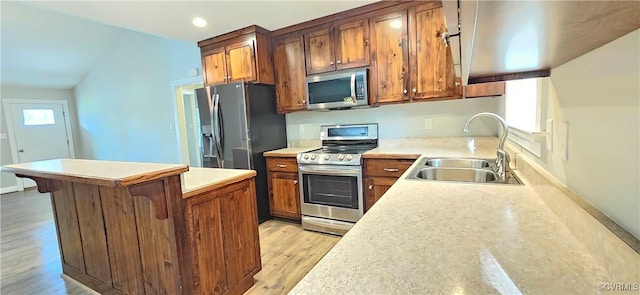 379 Moncuin Ct, Manquin, VA 23106 - kitchen featuring stainless steel appliances, a sink, light wood-type flooring, light countertops, and brown cabinetry
