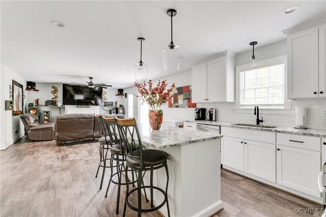 15606 Corte Castle Ter, Chesterfield, VA 23838 - kitchen with a sink, light wood-style floors, tasteful backsplash, a ceiling fan, and open floor plan