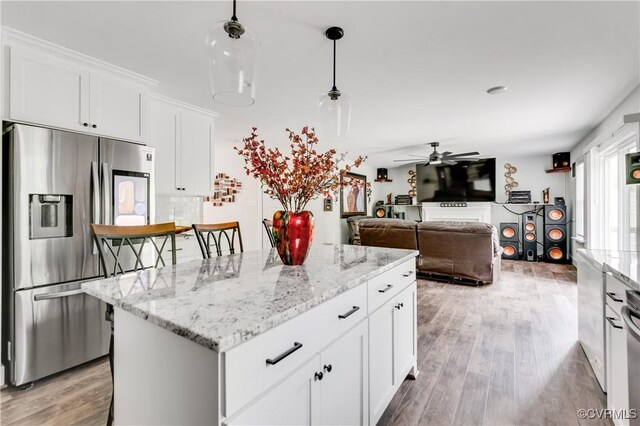 15606 Corte Castle Ter, Chesterfield, VA 23838 - kitchen with stainless steel fridge with ice dispenser, a ceiling fan, a center island, white cabinets, and light wood finished floors