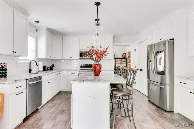 15606 Corte Castle Ter, Chesterfield, VA 23838 - kitchen featuring appliances with stainless steel finishes, a sink, light wood-style flooring, white cabinetry, and recessed lighting