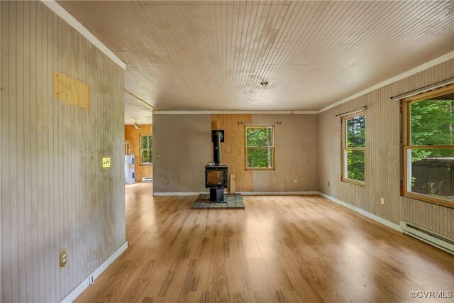 3966 Holts Ln, Saluda, VA 23149 - unfurnished living room featuring a wood stove, light wood finished floors, a baseboard radiator, wood walls, and ornamental molding