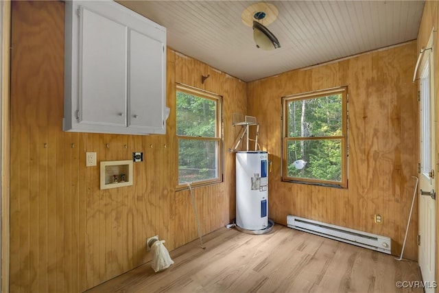 3966 Holts Ln, Saluda, VA 23149 - washroom featuring a baseboard heating unit, cabinet space, electric water heater, plenty of natural light, and wooden walls