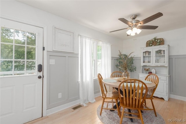 7313 Key Deer Cir, Midlothian, VA 23112 - dining room with a decorative wall, light wood finished floors, a ceiling fan, and wainscoting