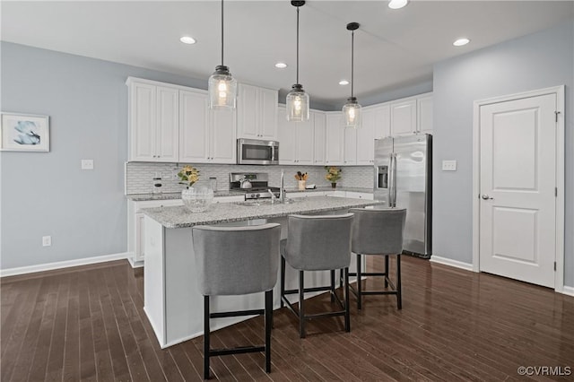 1012 Water Beech Rd, Midlothian, VA 23114 - kitchen featuring stainless steel appliances, white cabinetry, decorative backsplash, decorative light fixtures, and recessed lighting