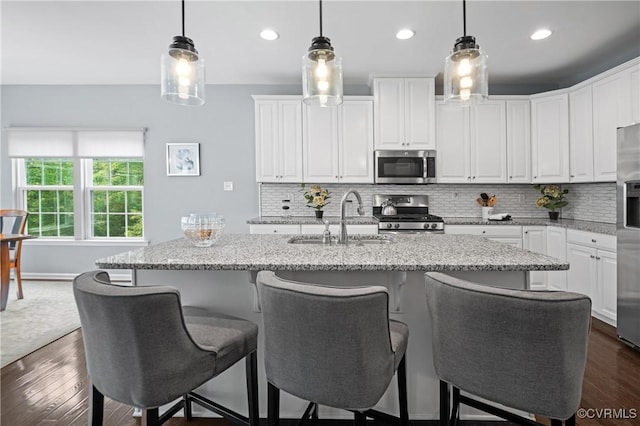 1012 Water Beech Rd, Midlothian, VA 23114 - kitchen featuring appliances with stainless steel finishes, a sink, white cabinets, tasteful backsplash, and recessed lighting
