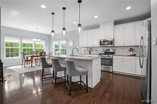 1012 Water Beech Rd, Midlothian, VA 23114 - kitchen featuring appliances with stainless steel finishes, a sink, a chandelier, white cabinetry, and dark wood-style floors