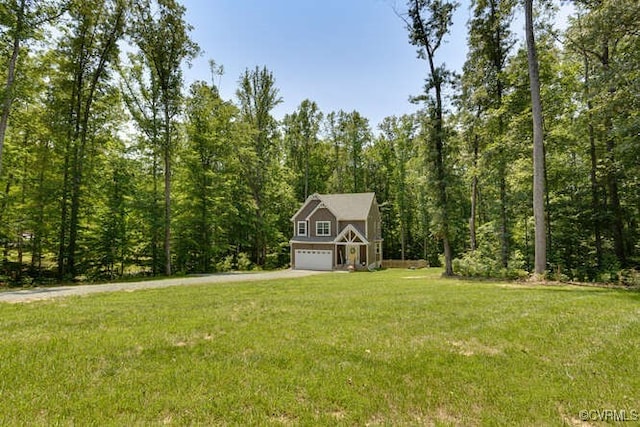 328 Peregrine Pl, Louisa, VA 23093 - view of green lawn featuring an attached garage, a wooded view, and driveway