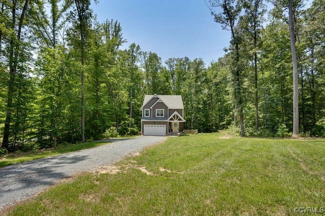 328 Peregrine Pl, Louisa, VA 23093 - view of front facade featuring gravel driveway, an attached garage, a wooded view, and a front lawn