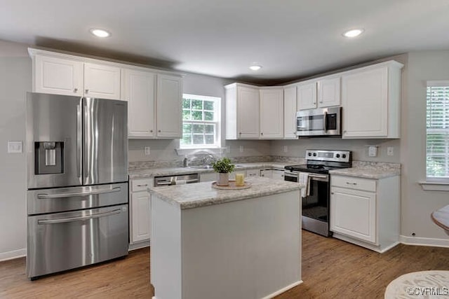 328 Peregrine Pl, Louisa, VA 23093 - kitchen featuring stainless steel appliances, white cabinets, wood finished floors, a kitchen island, and recessed lighting