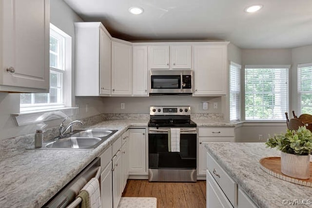 328 Peregrine Pl, Louisa, VA 23093 - kitchen with stainless steel appliances, white cabinetry, recessed lighting, and light wood-style flooring