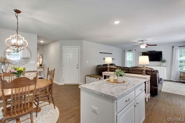 328 Peregrine Pl, Louisa, VA 23093 - kitchen featuring a ceiling fan, dark wood-style floors, a chandelier, open floor plan, and a center island