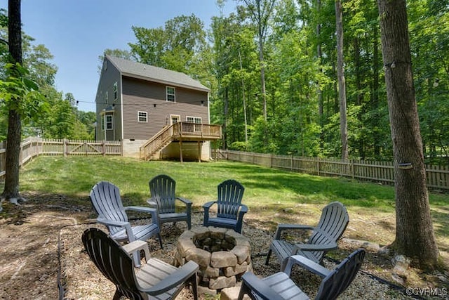 328 Peregrine Pl, Louisa, VA 23093 - rear view of house with an outdoor fire pit, stairway, a wooden deck, crawl space, and a fenced backyard
