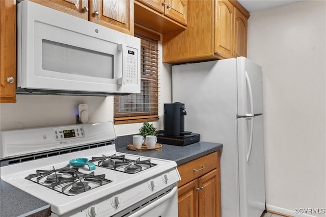 11605 E Briar Patch Dr, Midlothian, VA 23113 - kitchen featuring white appliances, brown cabinetry, and dark countertops