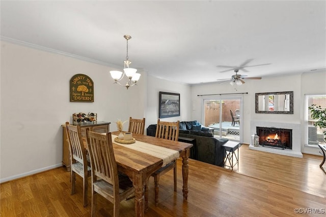 11605 E Briar Patch Dr, Midlothian, VA 23113 - dining space featuring wood finished floors, a brick fireplace, a chandelier, crown molding, and ceiling fan