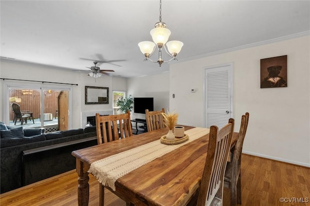 11605 E Briar Patch Dr, Midlothian, VA 23113 - dining room with a chandelier, light wood-style flooring, a ceiling fan, baseboards, and ornamental molding