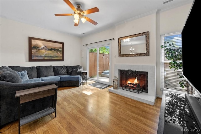 11605 E Briar Patch Dr, Midlothian, VA 23113 - living room with a fireplace, light wood finished floors, ceiling fan, and crown molding