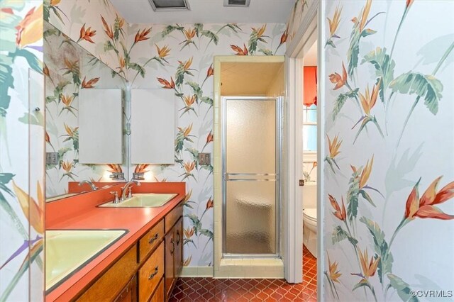 3301 E Princeton Rd, Petersburg, VA 23805 - bathroom with wallpapered walls, toilet, double vanity, a shower stall, and baseboards