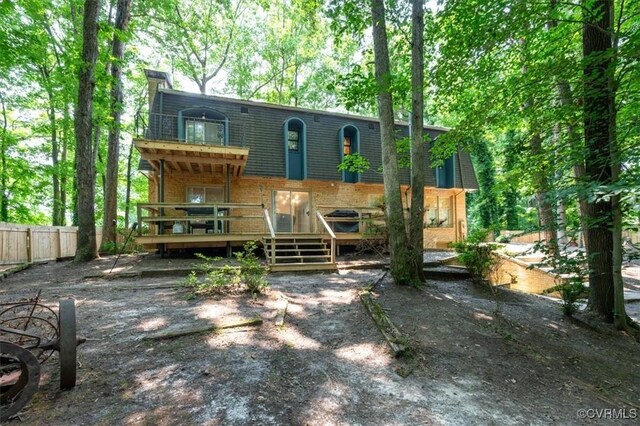 3301 E Princeton Rd, Petersburg, VA 23805 - back of house with mansard roof, brick siding, a wooden deck, and a chimney