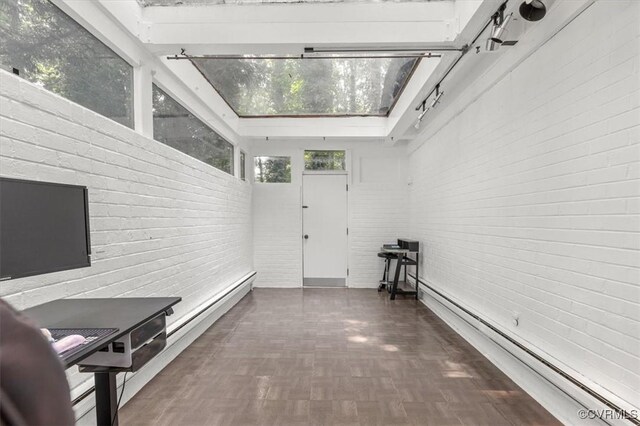 3301 E Princeton Rd, Petersburg, VA 23805 - corridor with baseboard heating, brick wall, and a skylight
