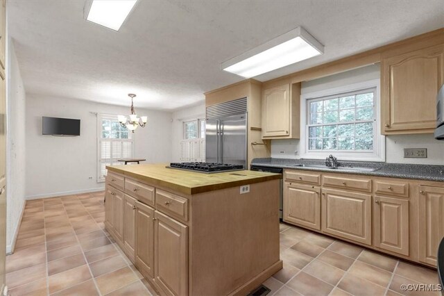 3301 E Princeton Rd, Petersburg, VA 23805 - kitchen featuring stainless steel appliances, butcher block counters, a sink, a chandelier, and light tile patterned flooring