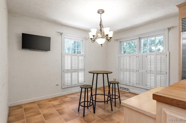 3301 E Princeton Rd, Petersburg, VA 23805 - dining area with plenty of natural light, a chandelier, light tile patterned floors, and baseboards
