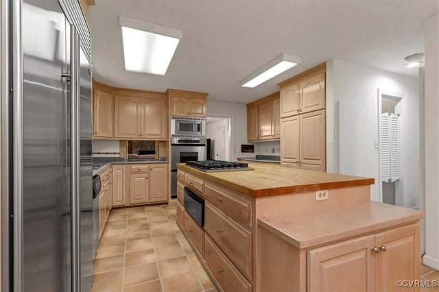 3301 E Princeton Rd, Petersburg, VA 23805 - kitchen featuring appliances with stainless steel finishes, light brown cabinets, a warming drawer, and wooden counters