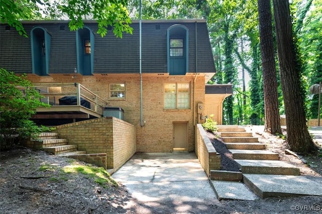 3301 E Princeton Rd, Petersburg, VA 23805 - back of property featuring stairs, mansard roof, and brick siding