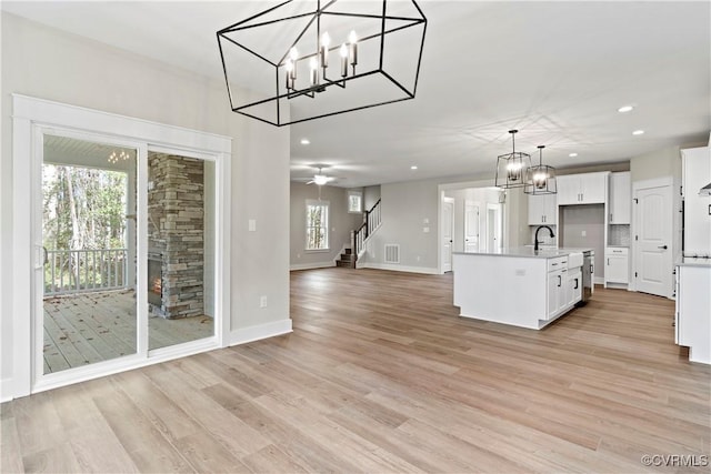 9027 Pine Hill Rd, Mechanicsville, VA 23116 - kitchen featuring recessed lighting, white cabinetry, open floor plan, light wood-style floors, and pendant lighting