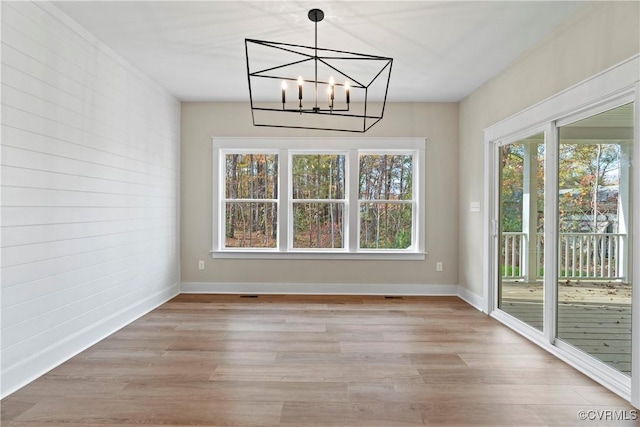 9027 Pine Hill Rd, Mechanicsville, VA 23116 - unfurnished dining area with light wood finished floors, a chandelier, and baseboards
