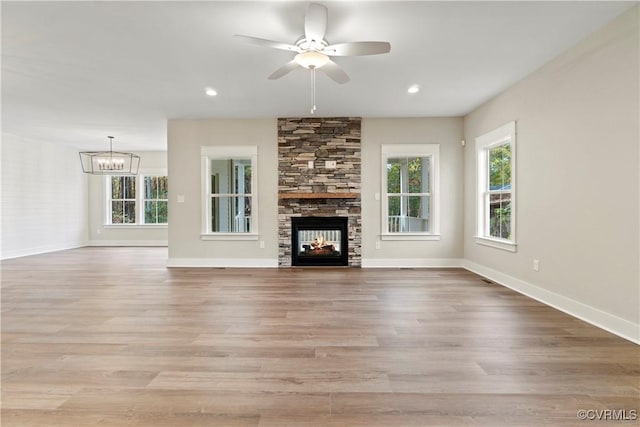 9027 Pine Hill Rd, Mechanicsville, VA 23116 - unfurnished living room featuring a stone fireplace, light wood-style flooring, baseboards, and recessed lighting