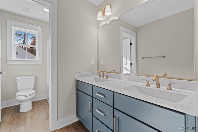 9027 Pine Hill Rd, Mechanicsville, VA 23116 - full bathroom featuring double vanity, wood finished floors, toilet, and baseboards