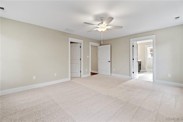 9027 Pine Hill Rd, Mechanicsville, VA 23116 - unfurnished bedroom with baseboards, light carpet, connected bathroom, and a ceiling fan