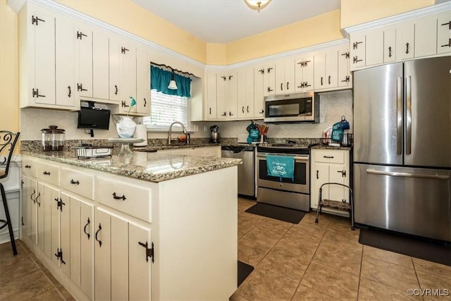 5120 Monza Ct, North Chesterfield, VA 23234 - kitchen with appliances with stainless steel finishes, a peninsula, a sink, decorative backsplash, and light tile patterned floors