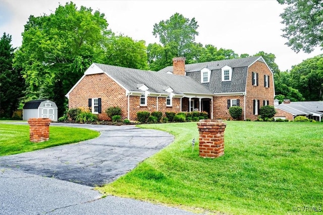 5120 Monza Ct, North Chesterfield, VA 23234 - view of front of property featuring a chimney, brick siding, a front lawn, asphalt driveway, and a gambrel roof