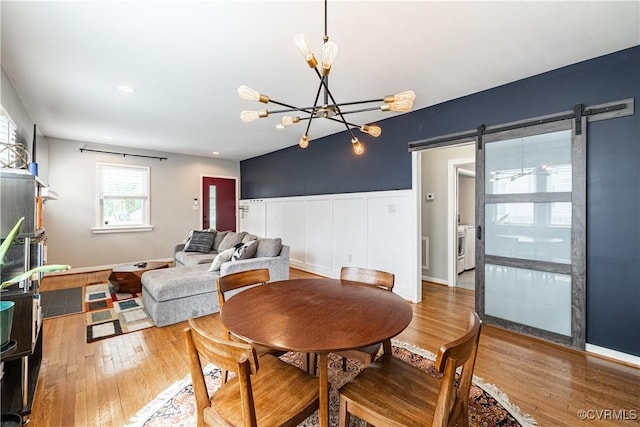 1815 Seddon Rd, Richmond, VA 23227 - dining area with a barn door, wood finished floors, and a chandelier