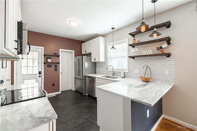 1815 Seddon Rd, Richmond, VA 23227 - kitchen featuring appliances with stainless steel finishes, a peninsula, healthy amount of natural light, and open shelves