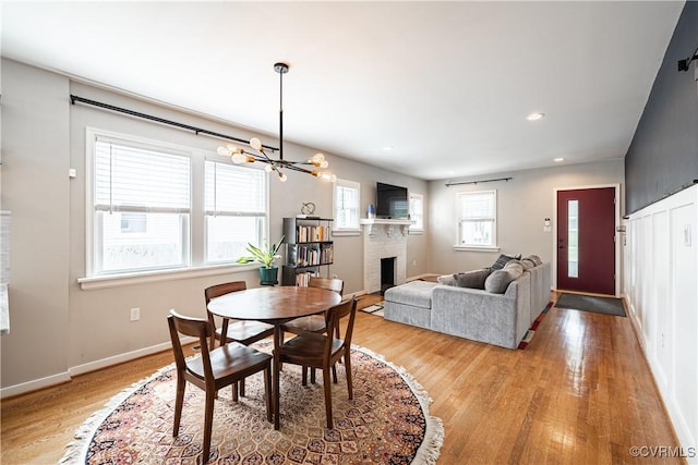 1815 Seddon Rd, Richmond, VA 23227 - dining space featuring a chandelier, light wood-style floors, a fireplace, and recessed lighting