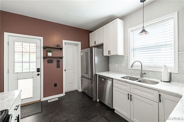 1815 Seddon Rd, Richmond, VA 23227 - kitchen featuring stainless steel appliances, tasteful backsplash, white cabinetry, light countertops, and hanging light fixtures